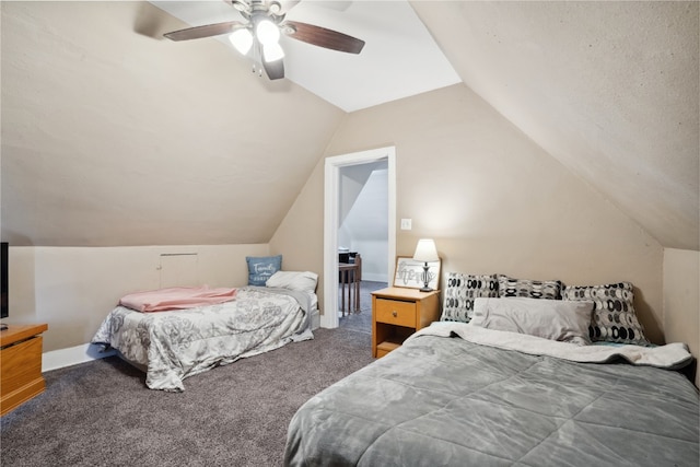 bedroom featuring lofted ceiling, dark carpet, and ceiling fan