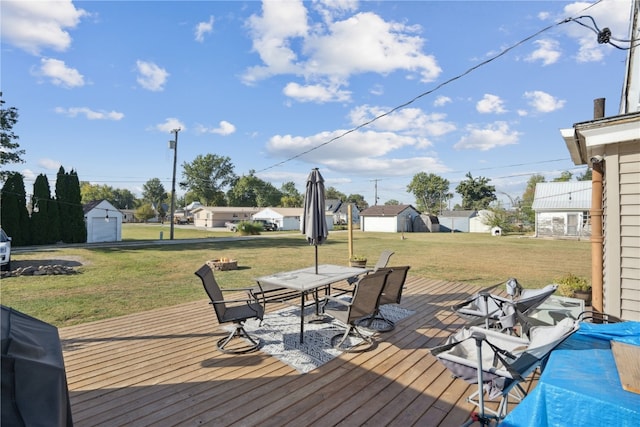 wooden deck with a storage shed and a yard