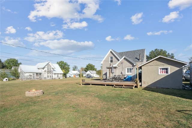 view of yard featuring a deck and a fire pit