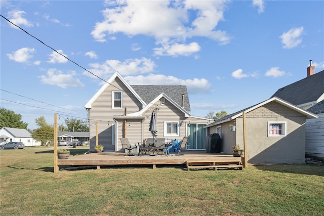 back of property featuring a deck and a lawn