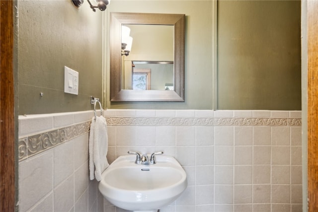 bathroom with tile walls and sink