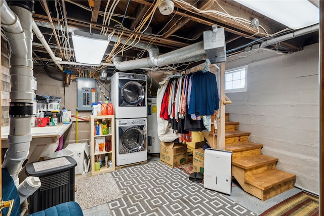 basement featuring stacked washer / dryer and electric panel