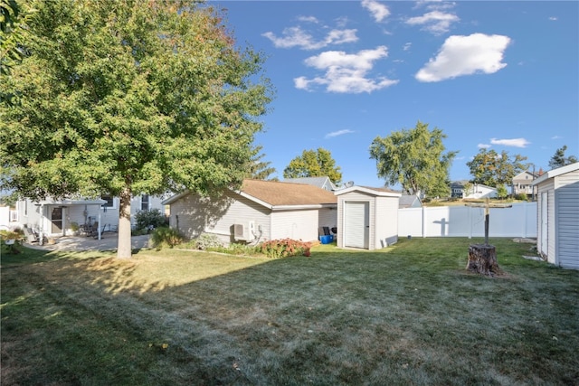 view of yard featuring a shed and a patio area