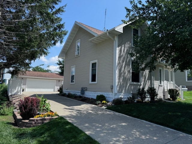 view of home's exterior featuring a lawn and a garage