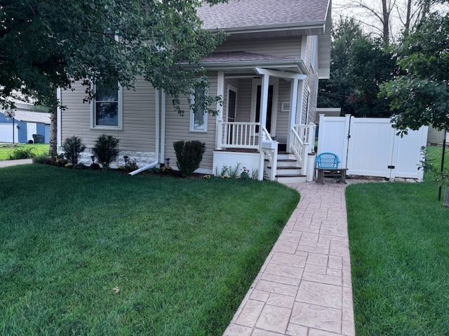 view of front of home with a front lawn and covered porch