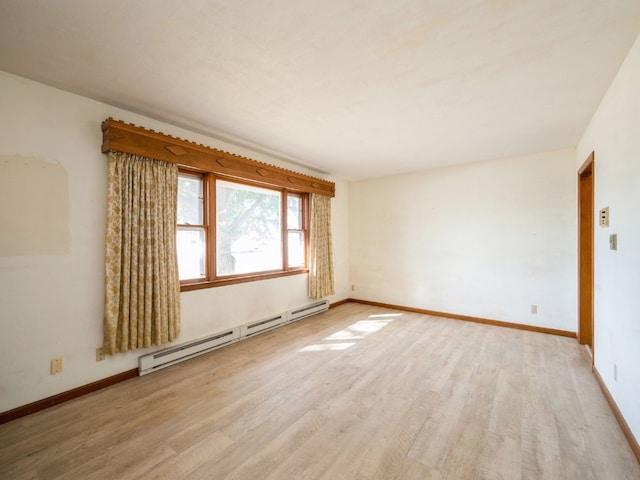 unfurnished room featuring light hardwood / wood-style flooring and a baseboard radiator