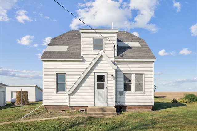 rear view of house with a lawn