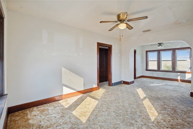 spare room featuring light carpet and ceiling fan