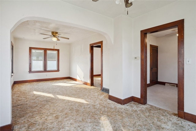 carpeted empty room featuring ceiling fan