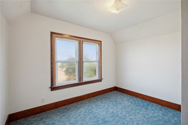 additional living space featuring carpet floors and vaulted ceiling