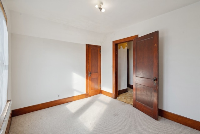 unfurnished bedroom featuring light colored carpet