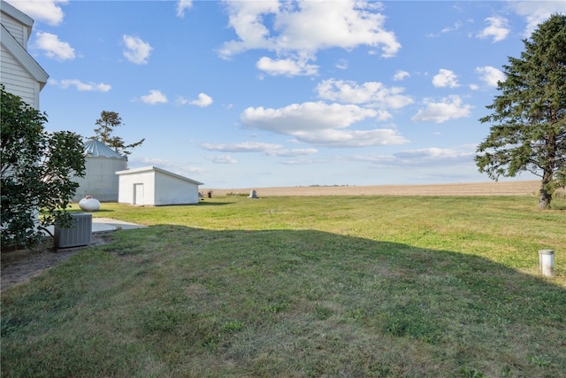 view of yard with cooling unit and a rural view