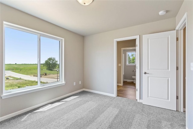 empty room with carpet floors and baseboards