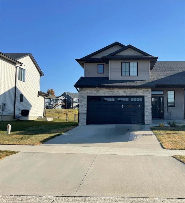 view of front facade featuring a front lawn and a garage