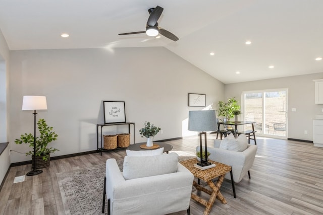 living room featuring high vaulted ceiling, light wood-type flooring, and ceiling fan