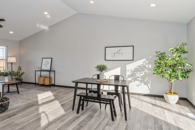 dining room featuring light hardwood / wood-style floors and vaulted ceiling