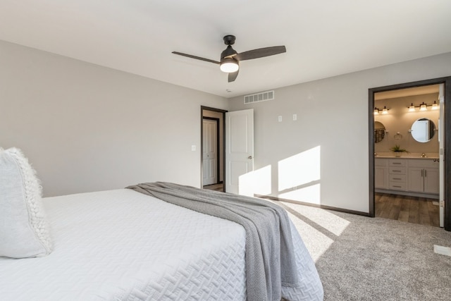 bedroom with connected bathroom, ceiling fan, and carpet flooring