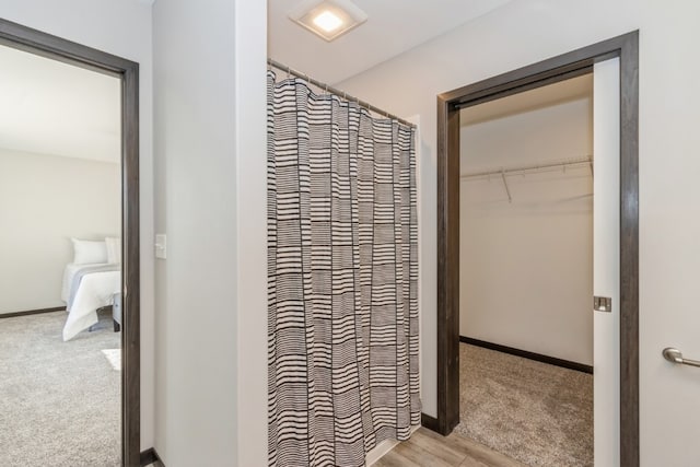 bathroom featuring a shower with curtain and hardwood / wood-style flooring