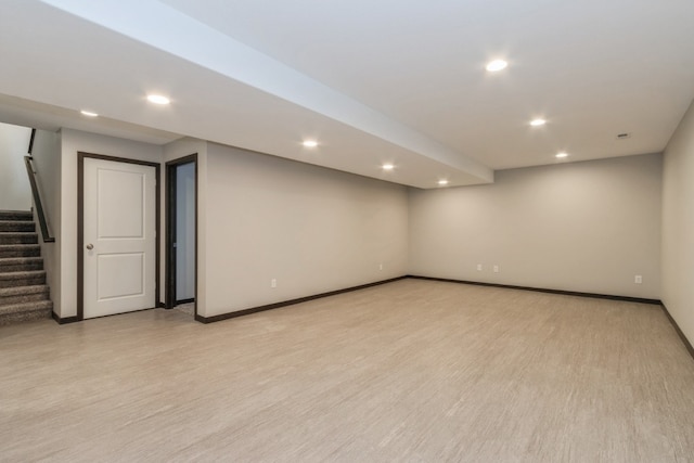 basement with light hardwood / wood-style floors