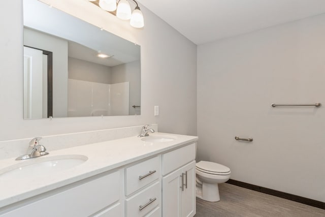 bathroom featuring hardwood / wood-style flooring, vanity, and toilet