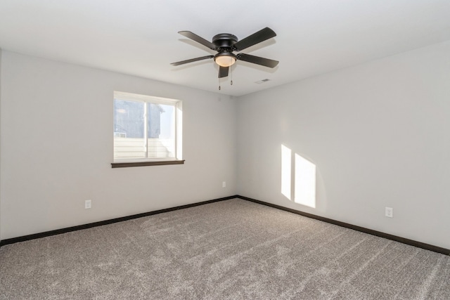 carpeted spare room featuring ceiling fan