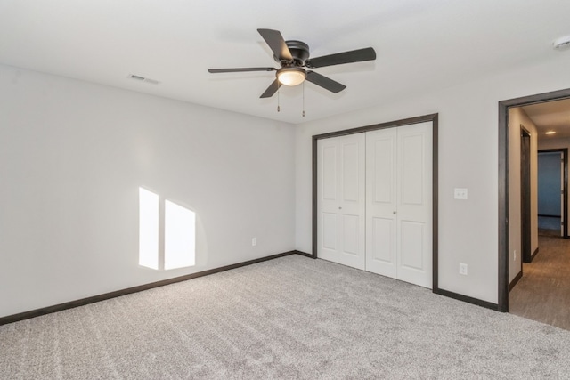 unfurnished bedroom featuring a closet, ceiling fan, and carpet flooring