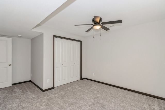 unfurnished bedroom with ceiling fan, a closet, and carpet