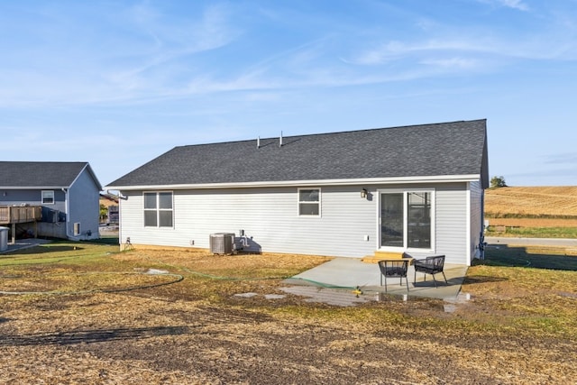 back of house featuring a patio, a yard, and central air condition unit