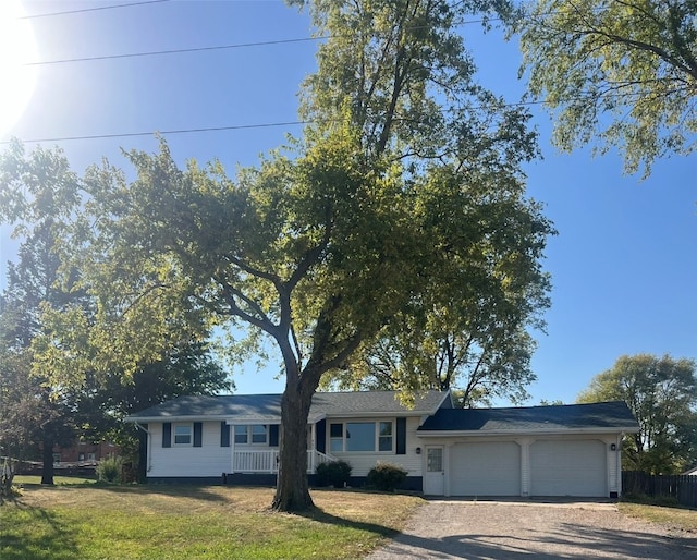 single story home featuring a garage and a front lawn