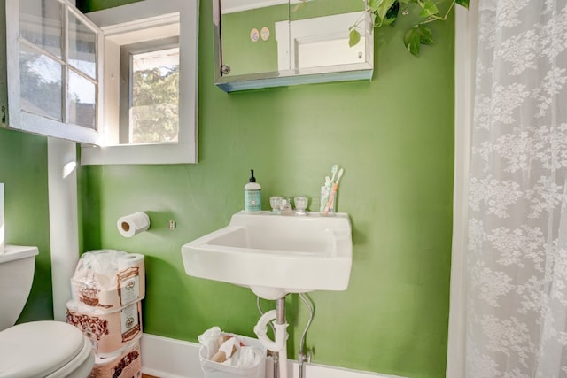 bathroom with a shower with curtain and toilet