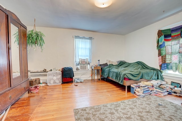 bedroom featuring hardwood / wood-style flooring and cooling unit