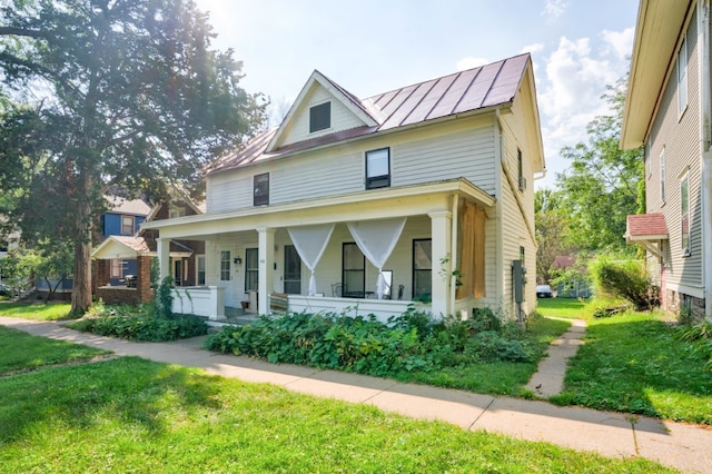 view of front of house with a front lawn and a porch