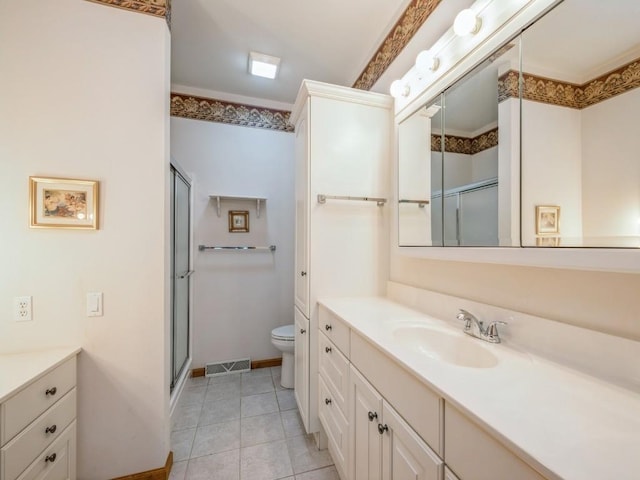 bathroom featuring toilet, visible vents, vanity, tile patterned floors, and a stall shower