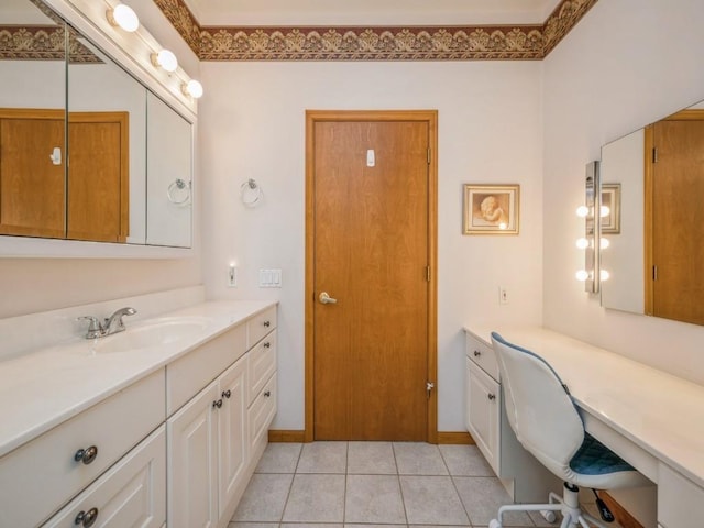 bathroom with baseboards, vanity, and tile patterned floors