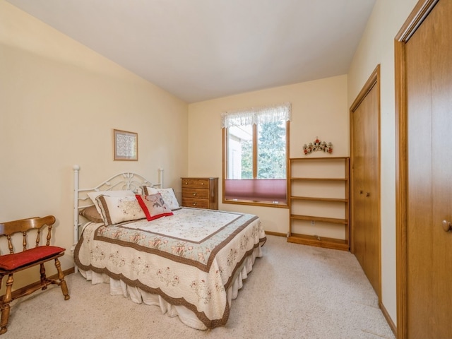 bedroom with two closets and light colored carpet