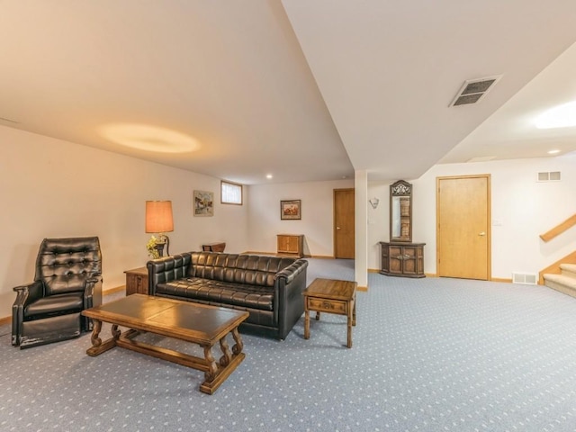 living area with carpet floors, stairs, and visible vents