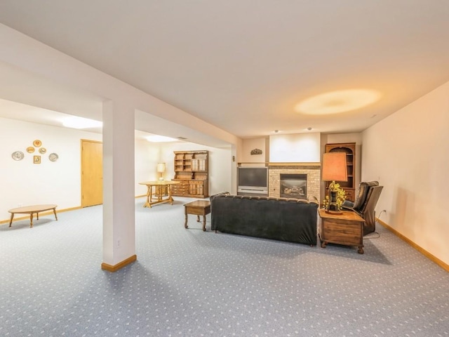 carpeted living area featuring a fireplace and baseboards