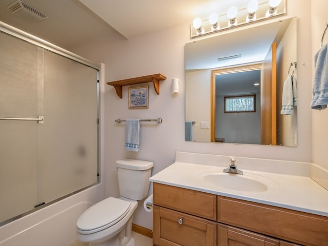 full bathroom featuring vanity, toilet, and combined bath / shower with glass door