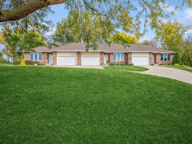 ranch-style home with a front yard and a garage