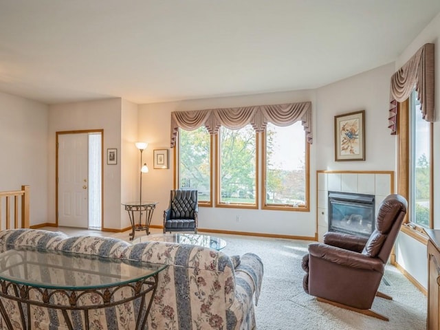 living room with a fireplace, carpet flooring, and baseboards