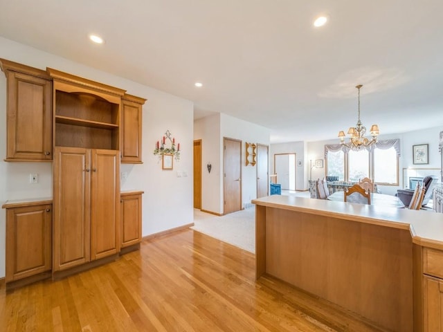 kitchen featuring pendant lighting, open shelves, light countertops, light wood-style flooring, and brown cabinetry