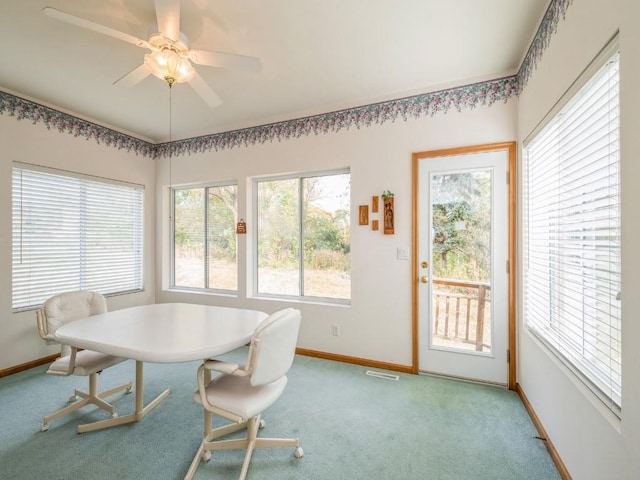 dining space with light carpet, a ceiling fan, visible vents, and baseboards