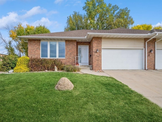 ranch-style house with an attached garage, a front lawn, concrete driveway, and brick siding