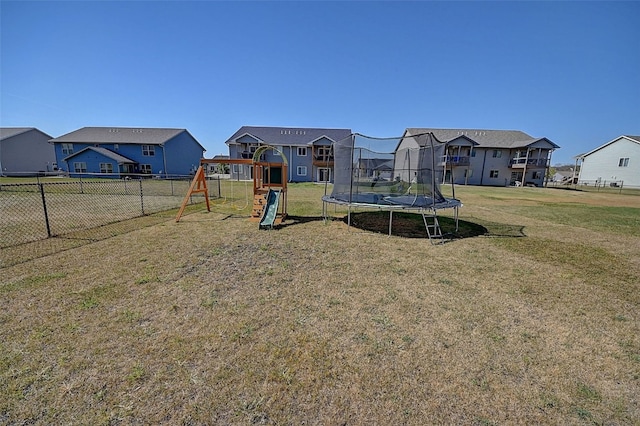 view of playground with a trampoline and a lawn