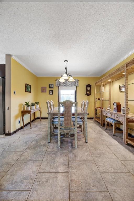 dining area featuring crown molding and a textured ceiling