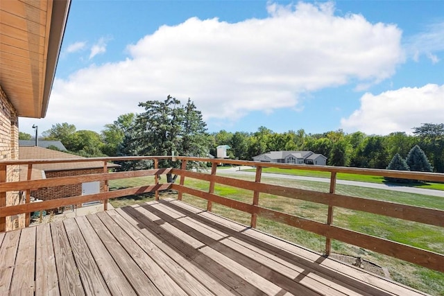 wooden terrace with a lawn