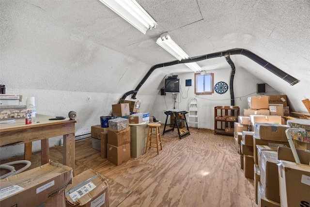 interior space featuring hardwood / wood-style floors and lofted ceiling