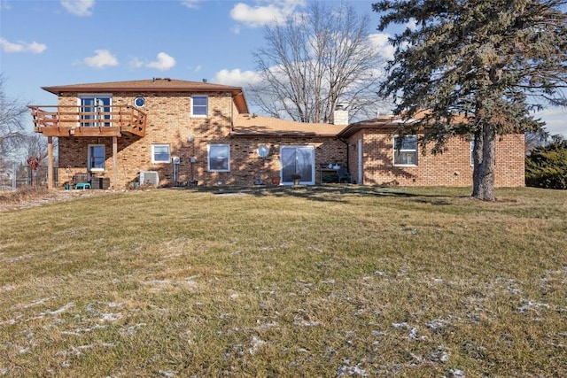 rear view of property featuring a lawn