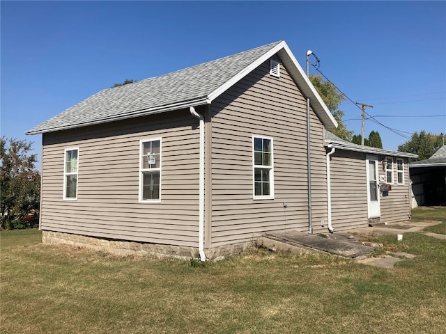 view of side of property with a lawn