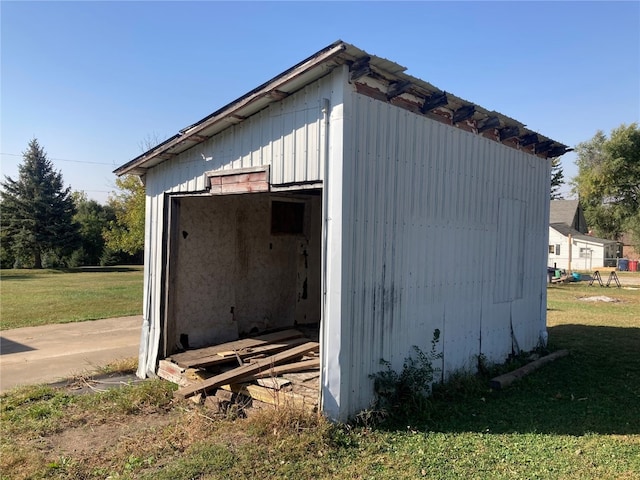 view of outbuilding featuring a lawn